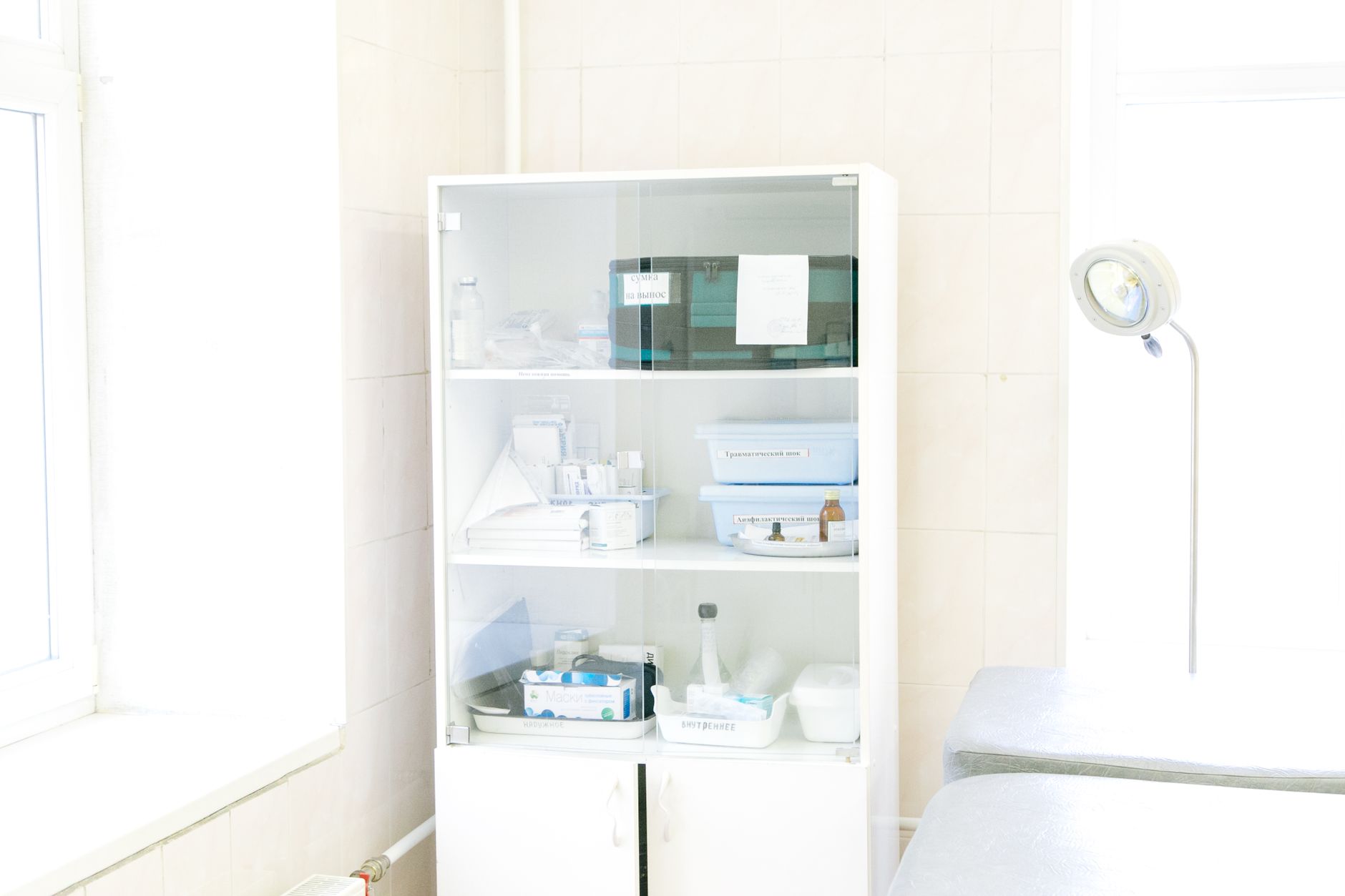 Open bathroom cabinet with toiletries arranged on its shelves.
